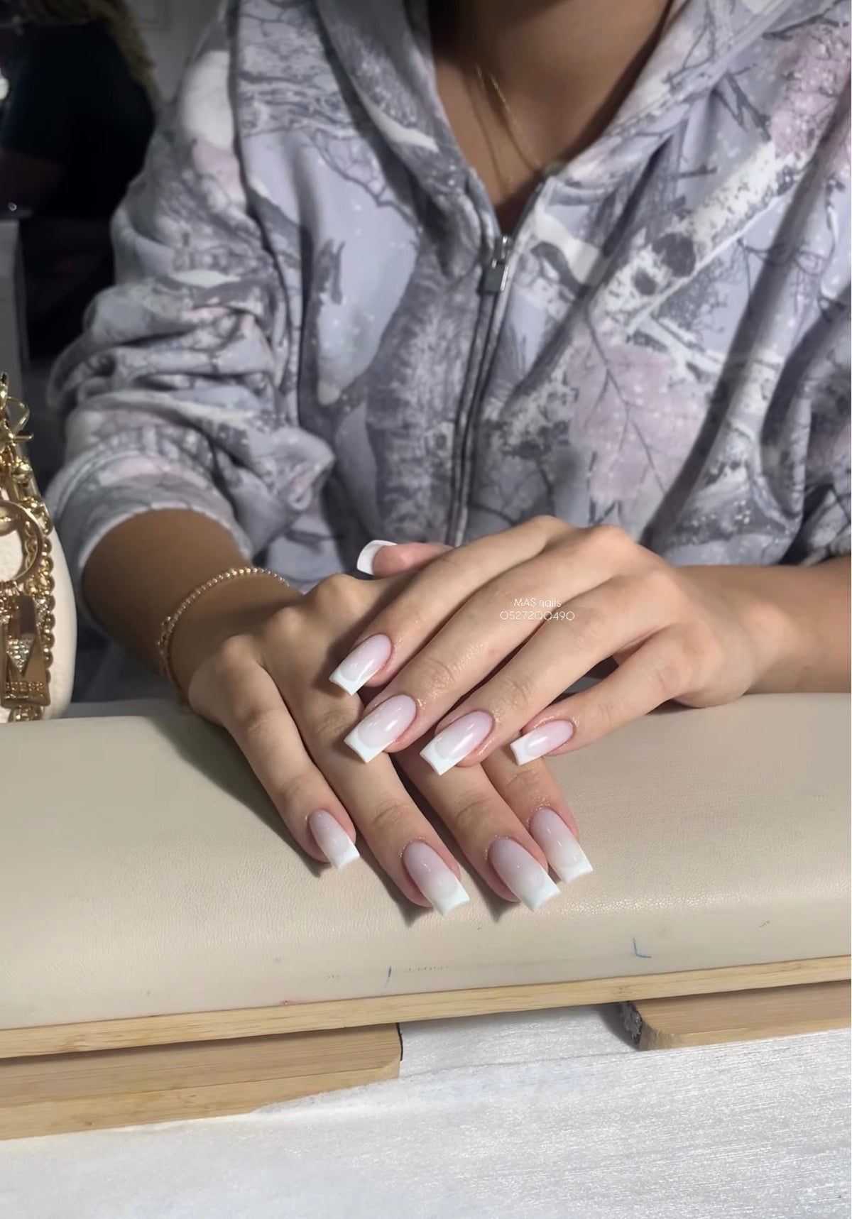 Crisp square French tip nail extensions with a milky white Russian base structure