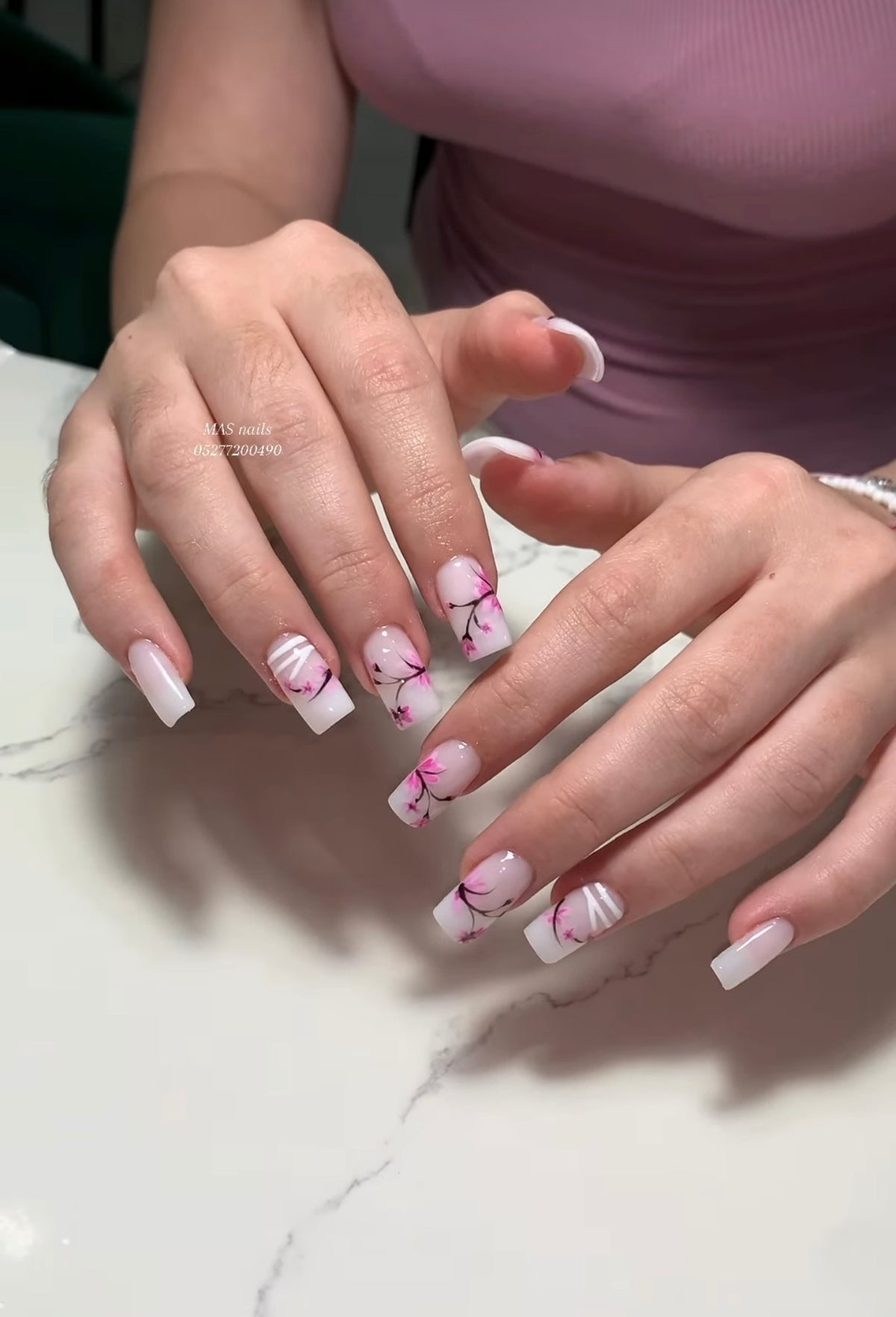 Square nail extensions featuring delicate Vietnamese style hand painted floral cherry blossom art